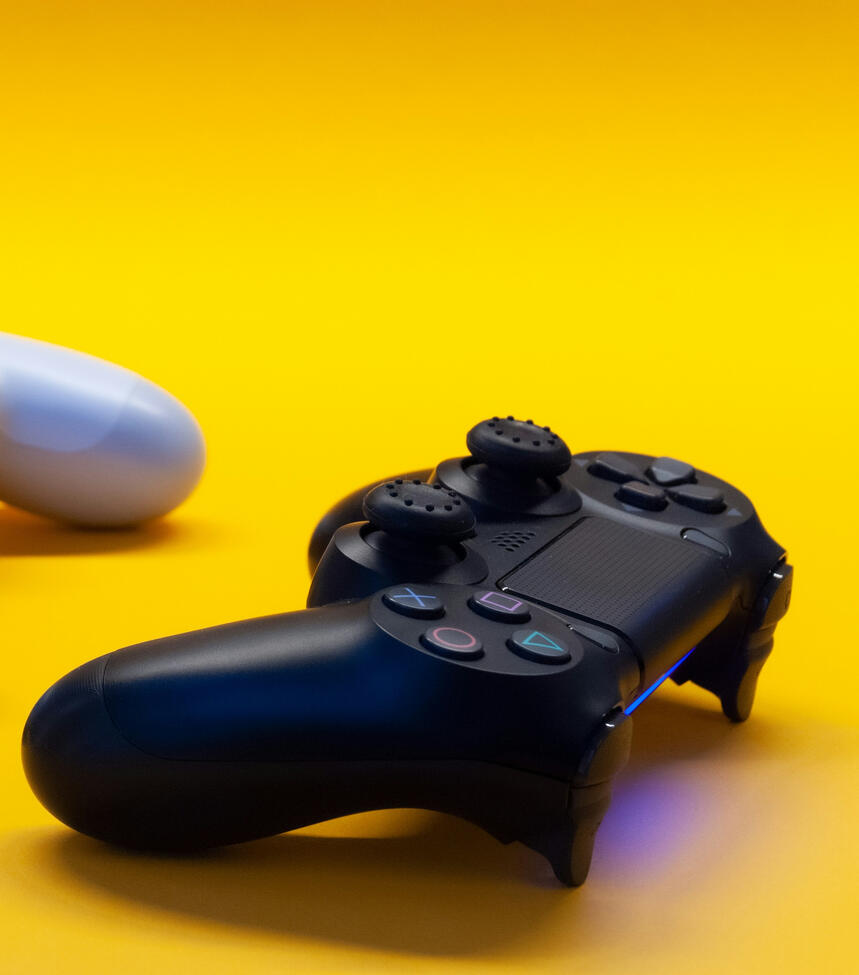 A video game controller in a yellow background.
