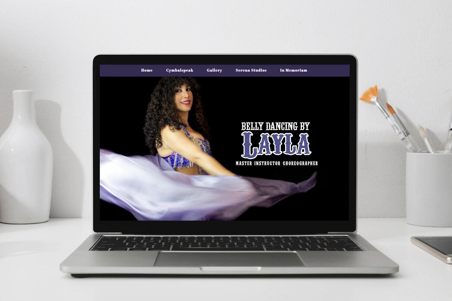 A laptop screen showing Bellydancing by Layla's homepage.